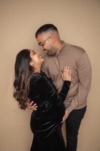 Elegant studio maternity portrait with flowing dress